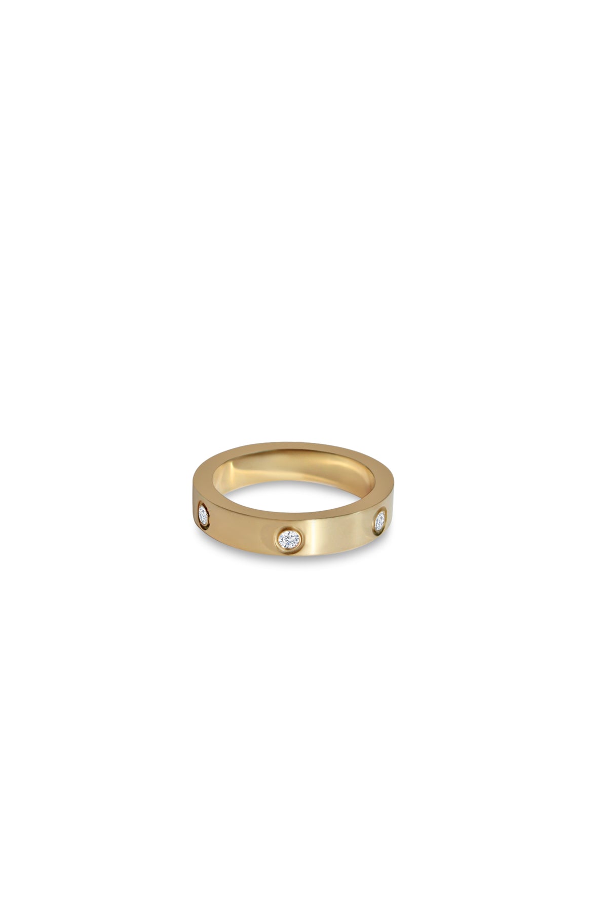 Carson gold-plated ring with spaced round cubic zirconia stones set into a smooth, flat band.